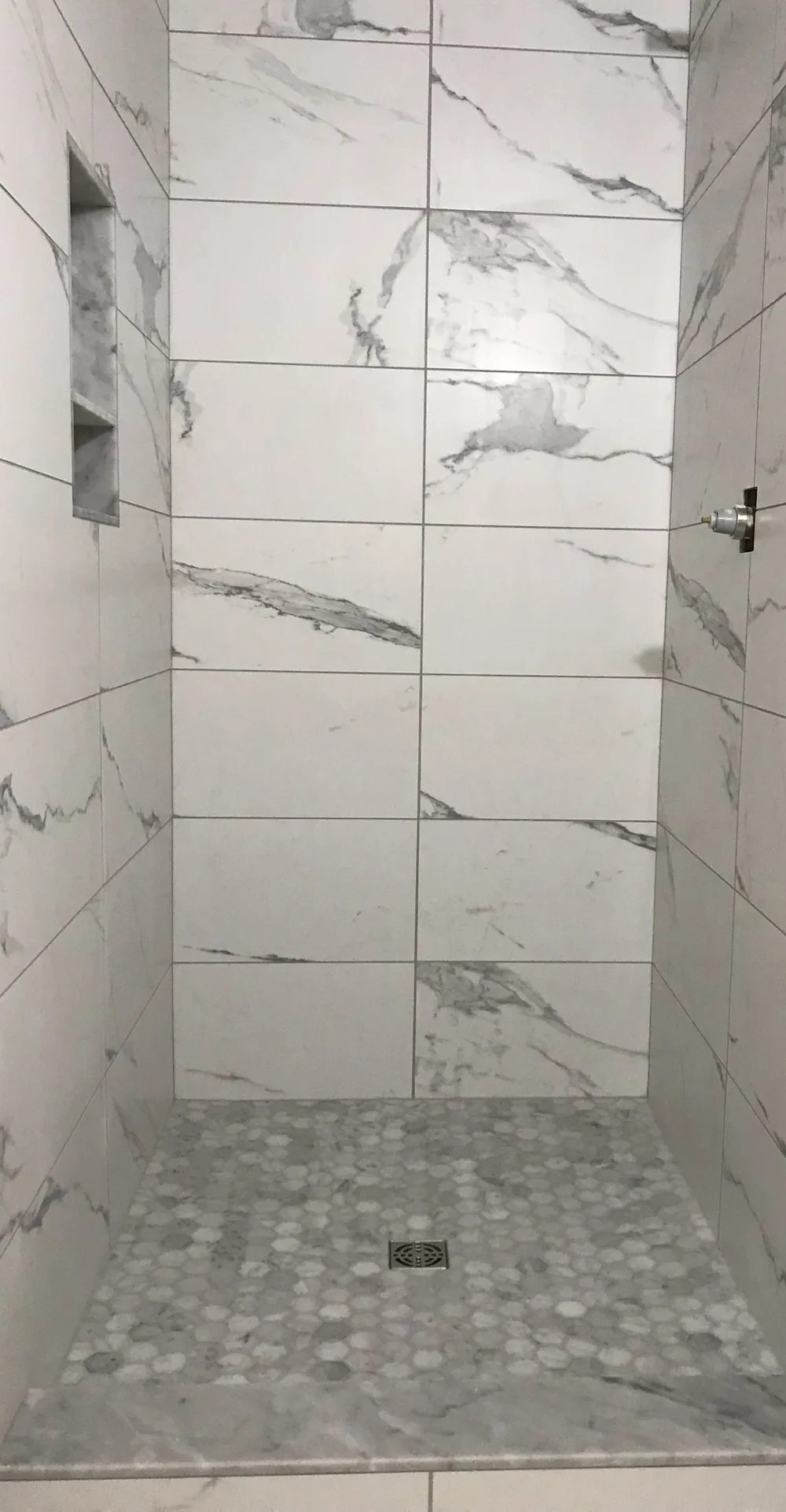 After: primary shower rebuild with marble tile